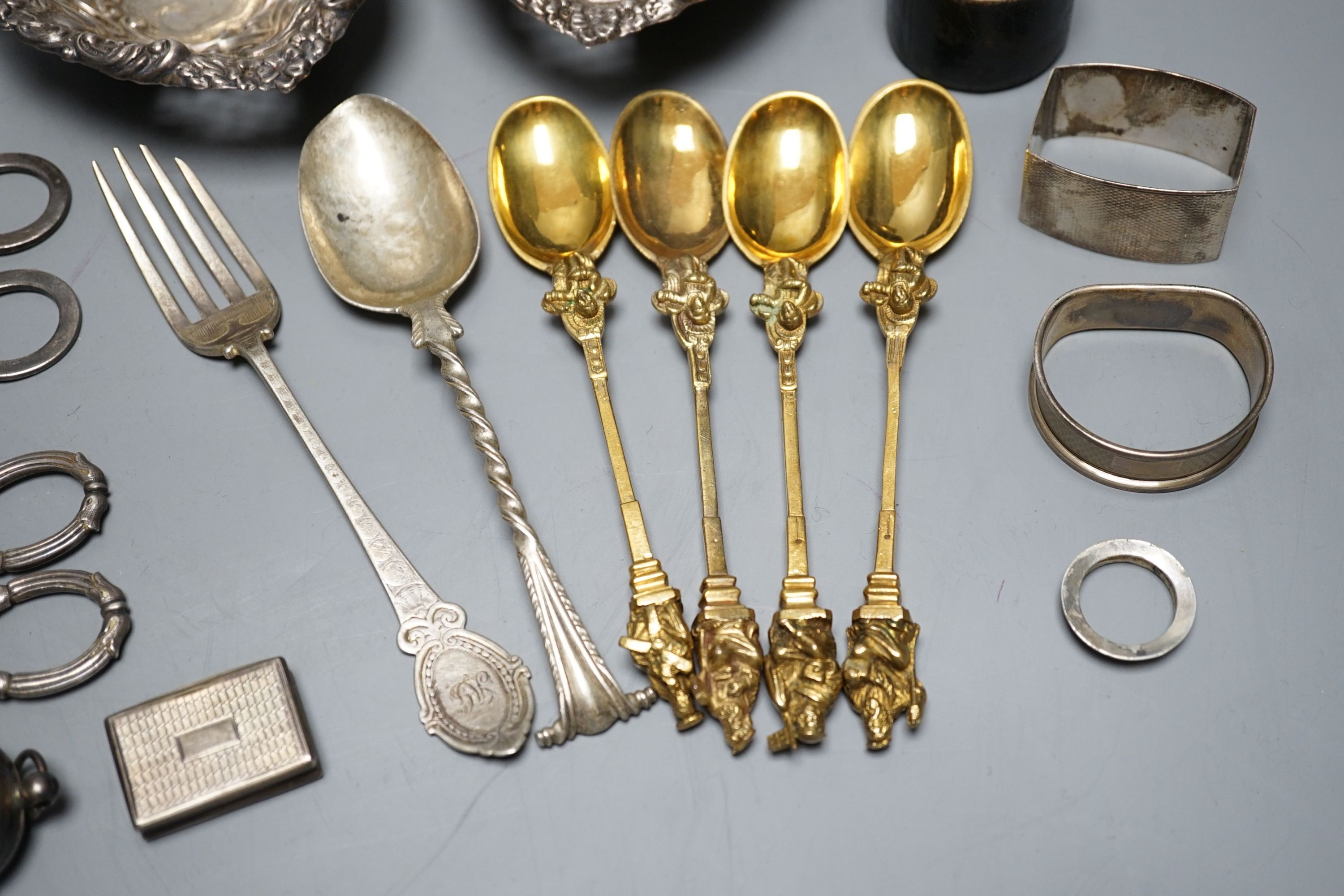 A cased Victorian silver part communion set, a silver cigarette case, two silver napkin rings, a set of five pierced silver bonbon dishes, a pair of Victorian silver grape shears, Georgian silver vinaigrette, pair of sil